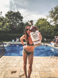 girl standing next to the pool