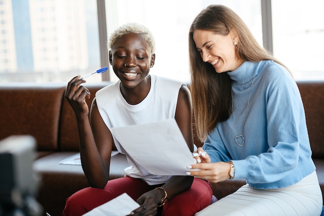 two ladies reading document